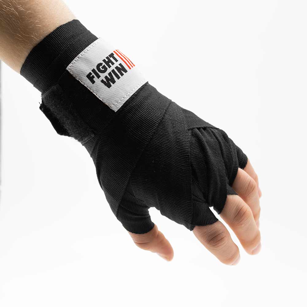 Completed black hand wrap with closed Fight2Win hook-and-loop fastener at the wrist.
