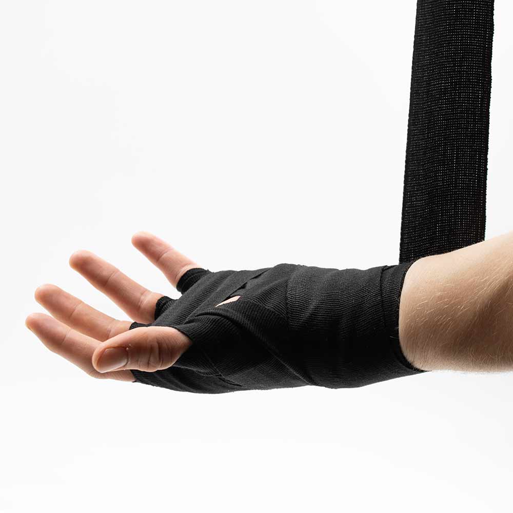 Palm side while wrapping, with a diagonal wrap between the hand and wrist.