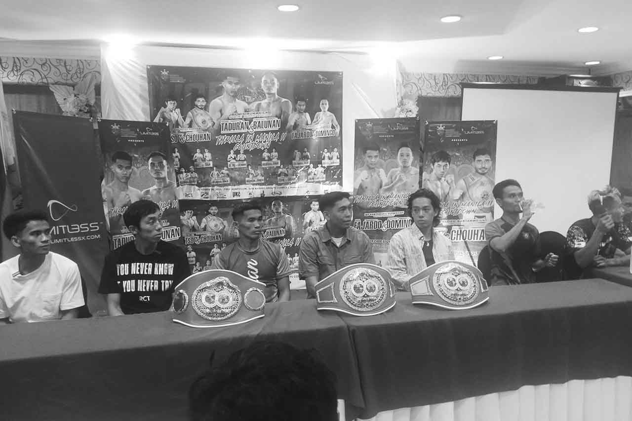 Press conference for the Taduran vs. Balunan boxing event, with speakers and championship belts at the table